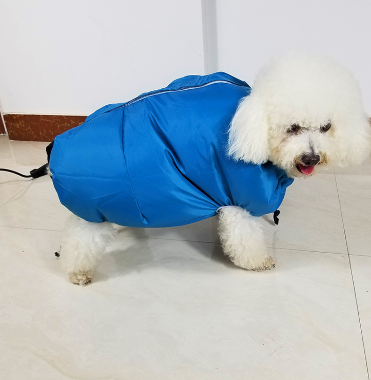 A fluffy dog in a bright blue drying bag stands on a tiled floor, showcasing the Pet Drying Box, Dryer, and Drying Bag by Pur
