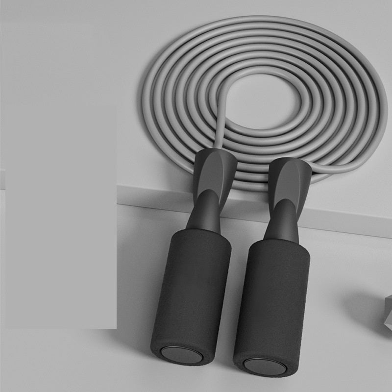 Cordless Dual-use Skipping Rope coiled neatly, featuring ergonomic handles, for home fitness by PureAura.