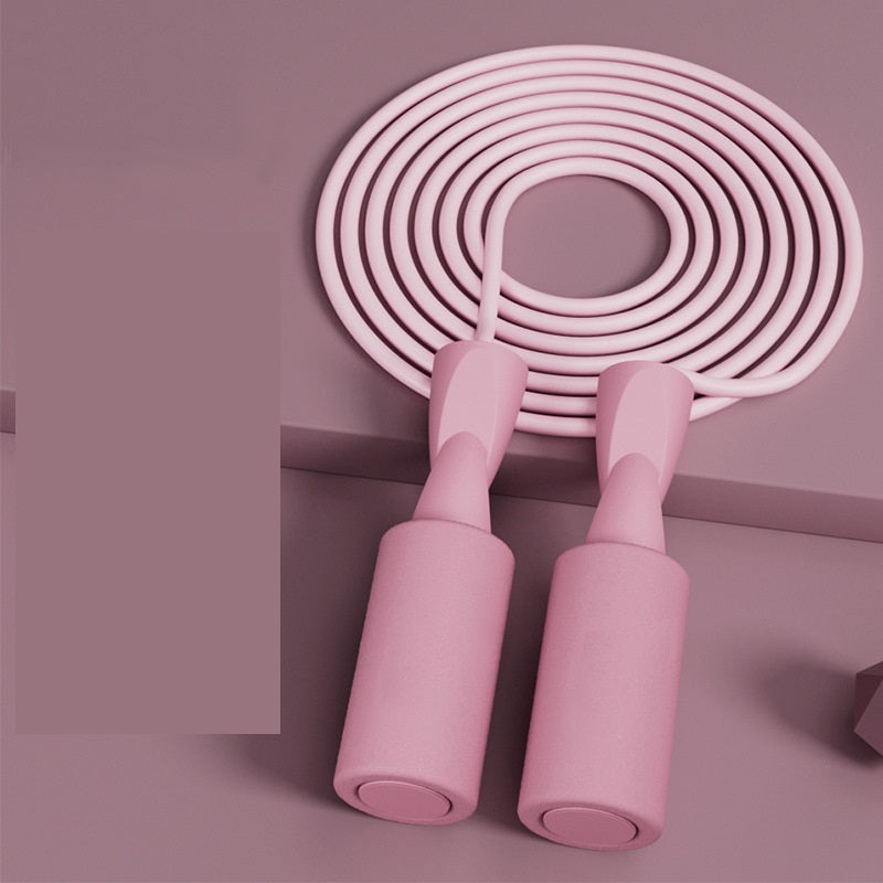 Light pink Cordless Dual-use Skipping Rope resting in a circular arrangement, perfect for home fitness by PureAura.