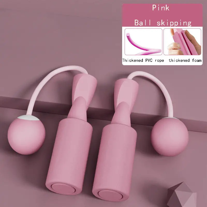 Pink cordless dual-use skipping rope with thickened PVC rope and foam handles displayed on a textured surface by PureAura.