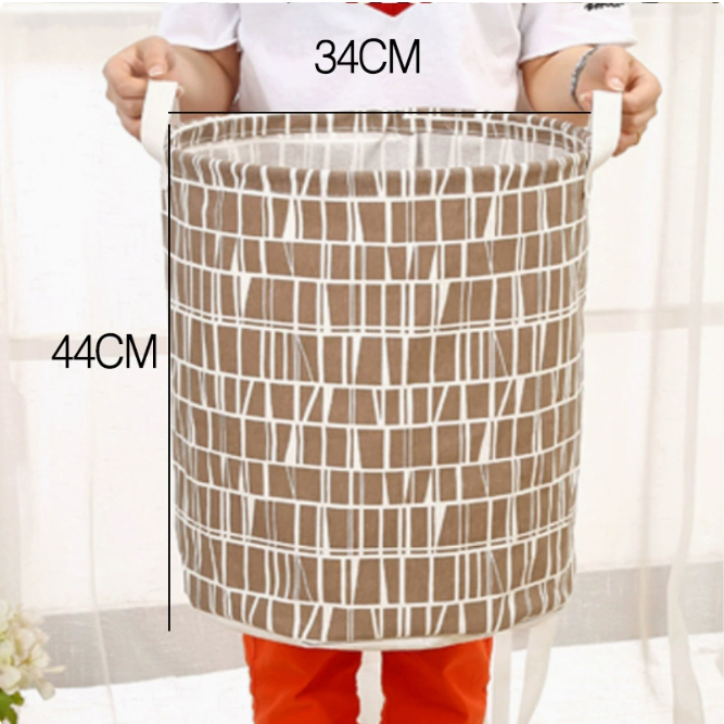 A person holds the Large Capacity Cotton Linen Laundry Basket with a distinctive geometric design, measuring 34CM x 44CM, by 