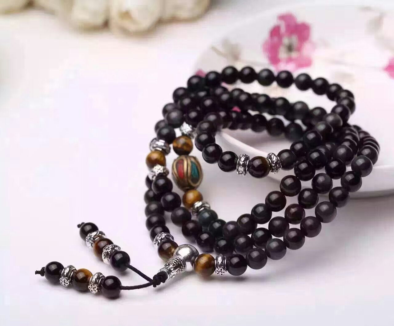 Elegant black obsidian bead bracelet mixed with colorful accents, displayed on a soft background, Obsidian Couple Bracelet an