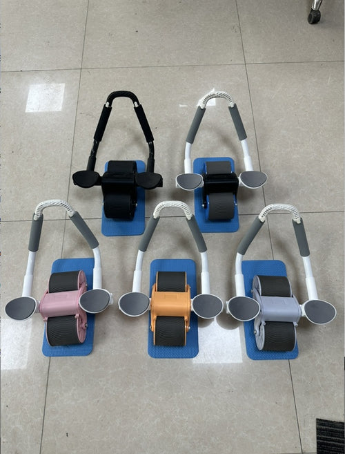 Five Automatic Rebound Abdominal Wheels in pink, orange, gray, and black on blue mats, showcasing various color options by Pu