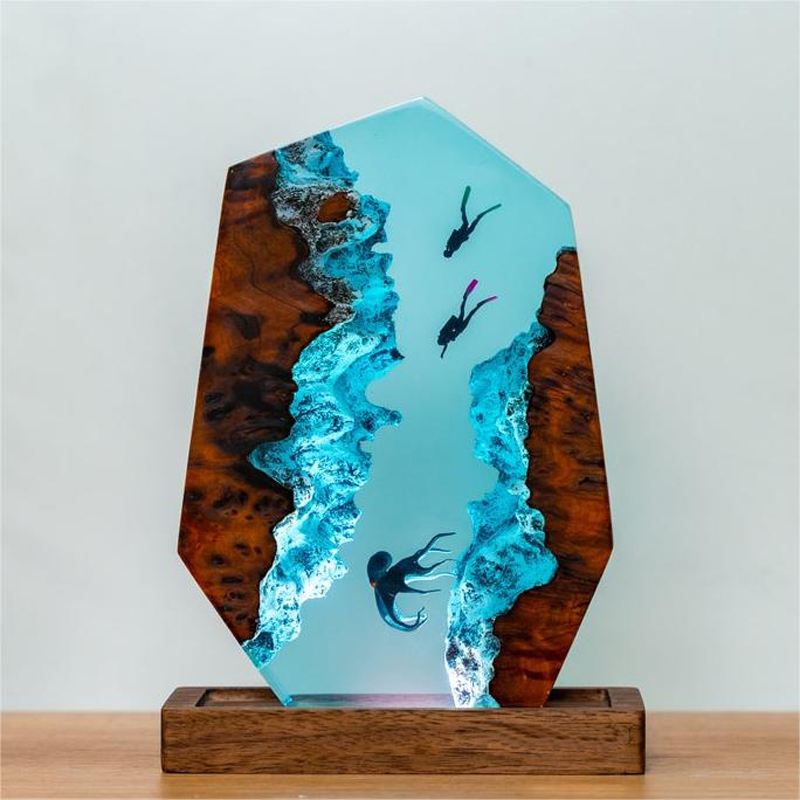 Intricate resin lamp featuring scuba divers and an octopus, showcasing unique blue tones in an artistic design by PureAura.