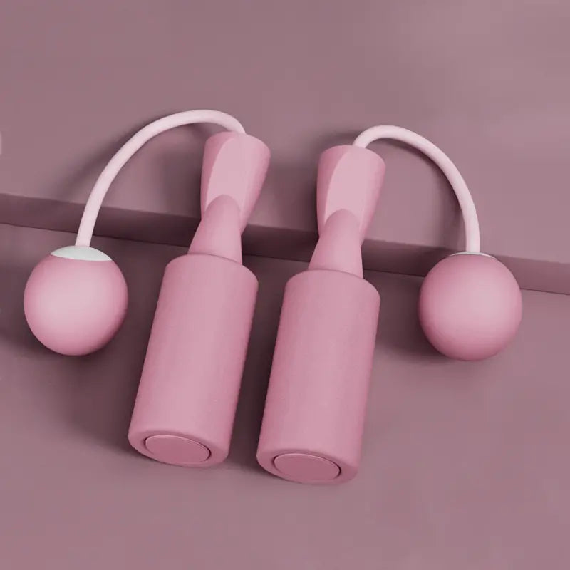 Close-up of the pink Cordless Dual-use Skipping Rope for Home Fitness with soft grips by PureAura.