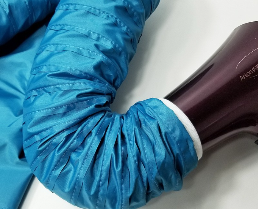 Close-up of the vibrant blue sleeve of the Pet Drying Box by PureAura, highlighting its unique material texture.