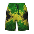 Colorful Jamaica-themed swim trunks featuring a vibrant splatter design in green, yellow, and black by PureAura.