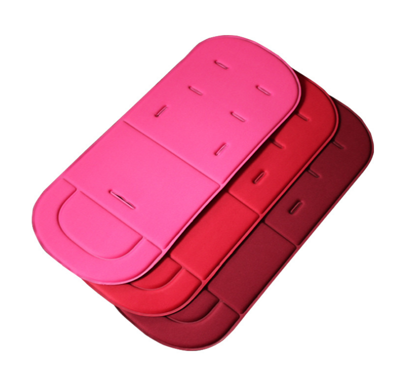 Vibrant stacked baby stroller cushions in pink and red shades, featuring a soft material for comfort by PureAura.