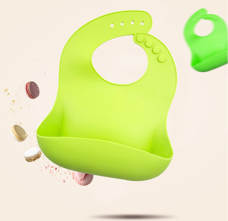 Bright green Waterproof Baby Bibs with a unique scoop design, shown against colorful macarons, by PureAura.
