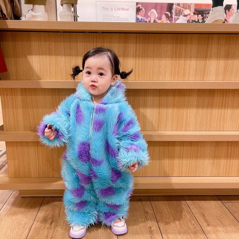 Adorable baby in a fluffy blue and purple hooded jumpsuit, showcasing the Cute Animal Baby Jumpsuit With Hooded Zipper by Pur