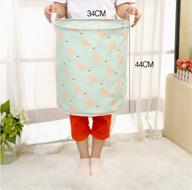 Large capacity cotton linen laundry basket with a fun flamingo design, held by a person in a cozy setting, by PureAura.