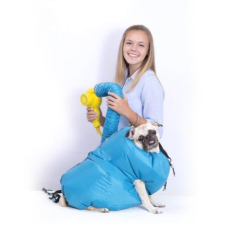 A smiling girl uses a drying tool on a dog inside a bright blue Pet Drying Box by PureAura.