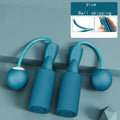 The blue Cordless Dual-use Skipping Rope rests on a textured surface, featuring ergonomic handles by PureAura.