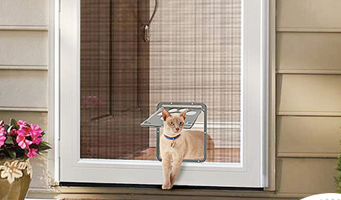 A cat using the Creative Pet Door with Scratch-Resistant Design, featuring a sleek frame by PureAura.