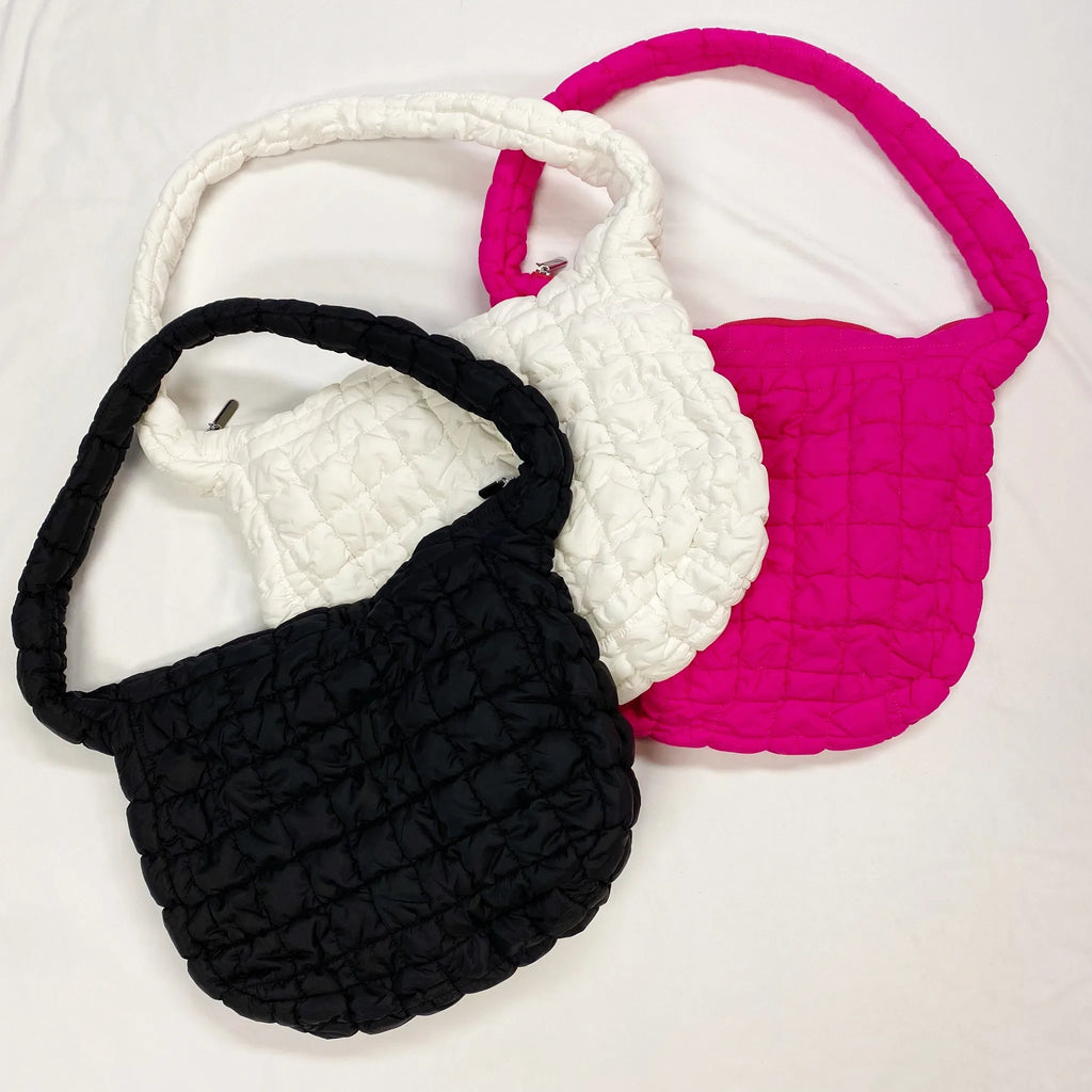 Three Carry All Quilted Cross Body Bags in black, white, and pink showcase their unique puffy design by My Store.
